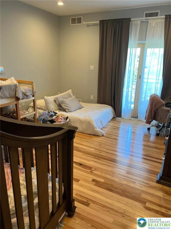 623 Walnut Street, Unit C2 Easton, PA 18042 - Photo 18 of 26 a bedroom with a bed and wooden floor