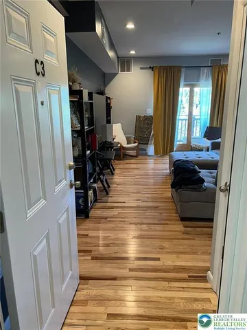 a living room with furniture and a wooden floor