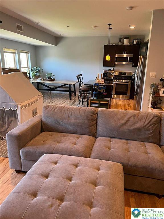 623 Walnut Street, Unit C2 Easton, PA 18042 - Photo 5 of 26 a living room with furniture and a flat screen tv