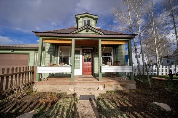a front view of a house with a potted plant