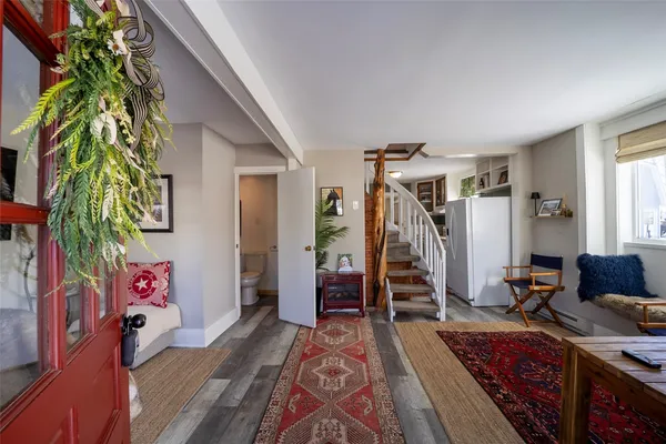 a living room with furniture a air conditioner and a window