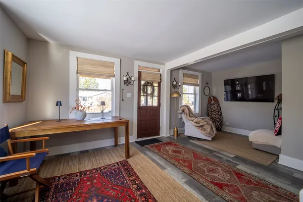 a living room with furniture and stairs