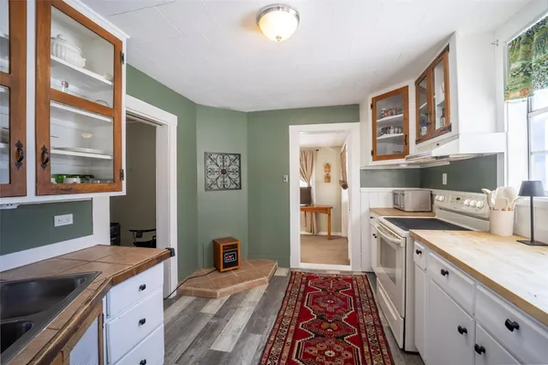 a kitchen with granite countertop a sink and cabinets