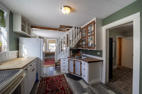 a view of a hallway with workspace and windows