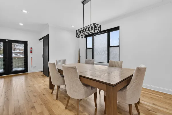 a view of a dining room with furniture and wooden floor