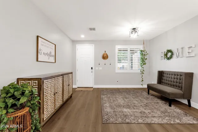 a view of entryway livingroom and hall with wooden floor
