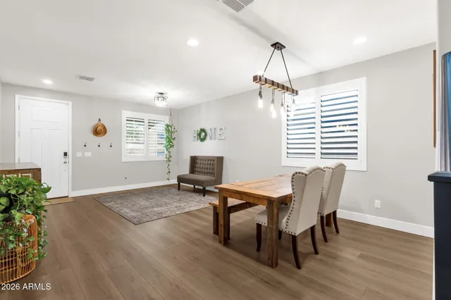 a view of a dining room with furniture window and wooden floor