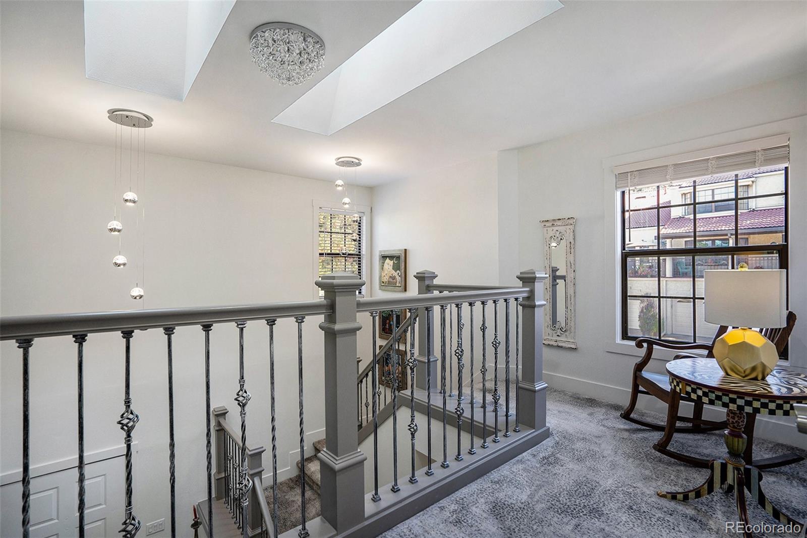 1600 South Quebec Way, Unit 10 Denver, CO 80231 - Photo 11 of 29 a view of a hallway with a dining table and chairs