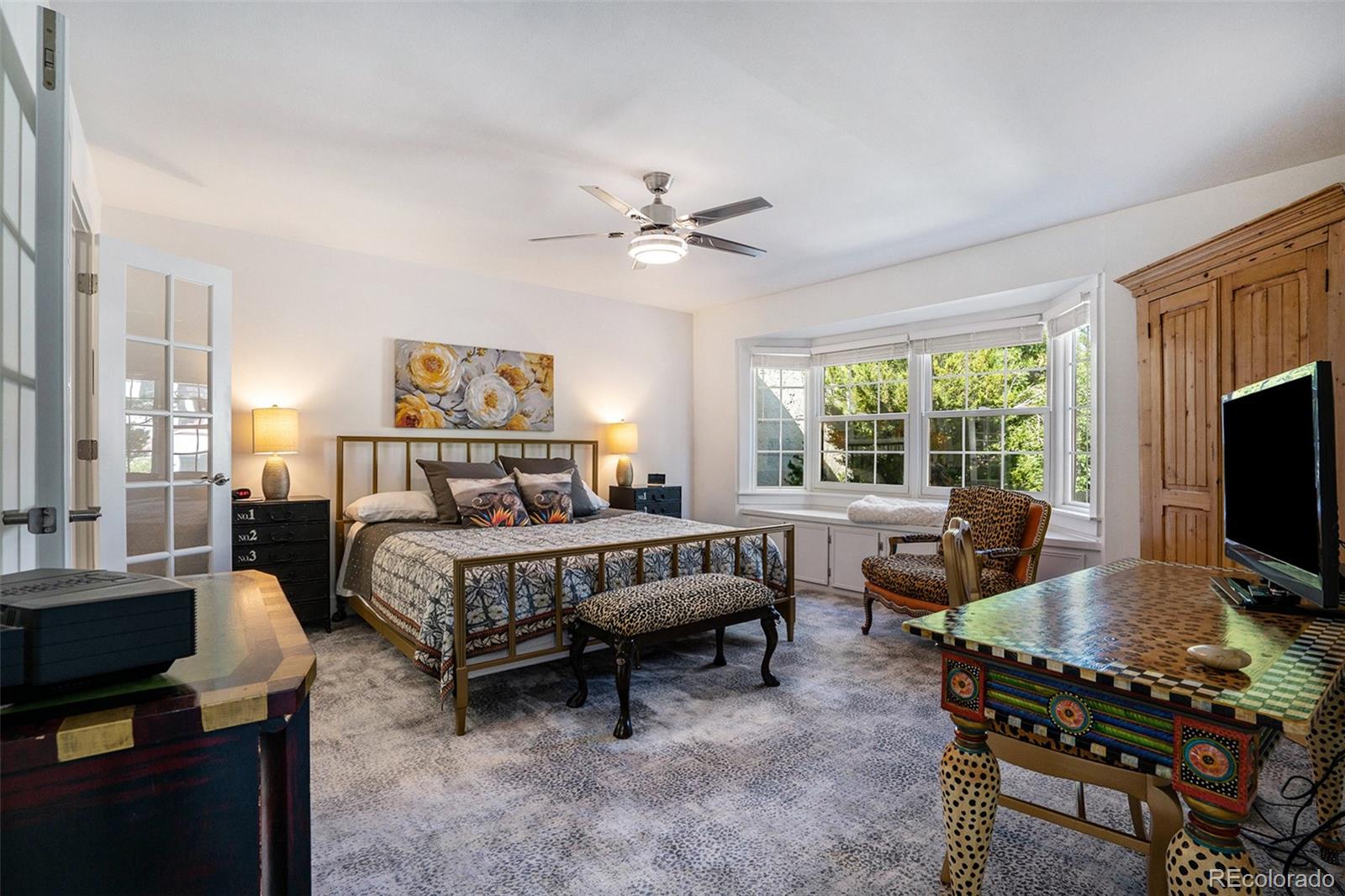 1600 South Quebec Way, Unit 10 Denver, CO 80231 - Photo 12 of 29 a bedroom with a bed and a desk