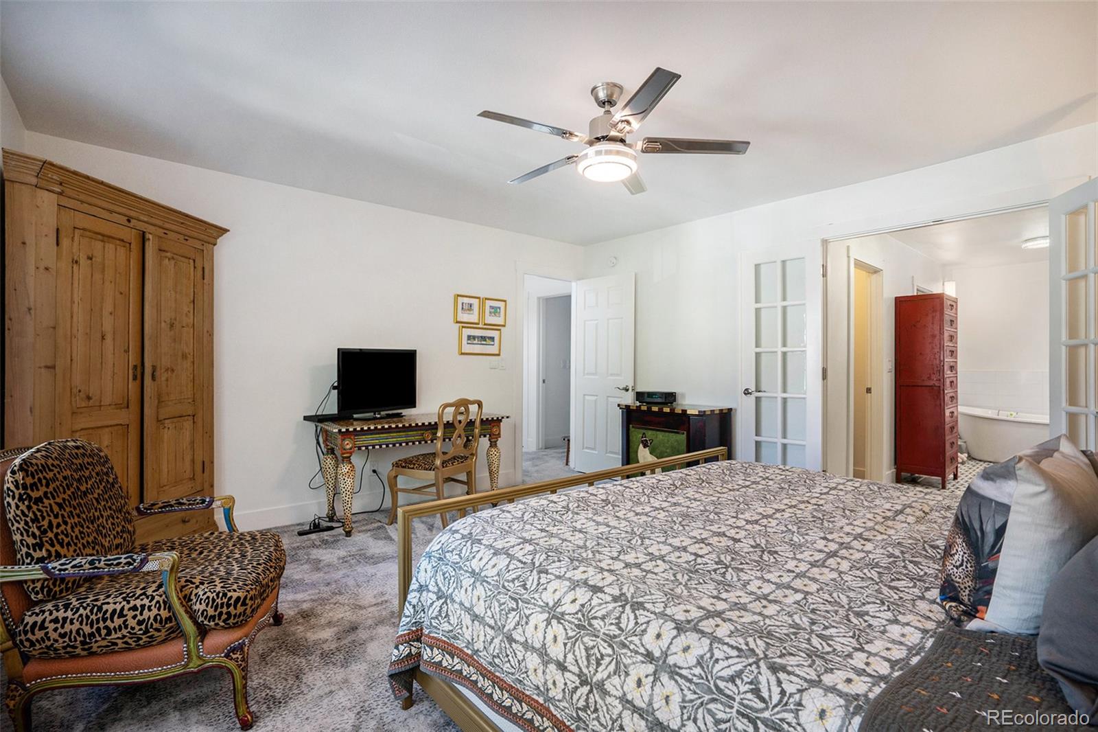 1600 South Quebec Way, Unit 10 Denver, CO 80231 - Photo 13 of 29 a bedroom with a bed and a desk