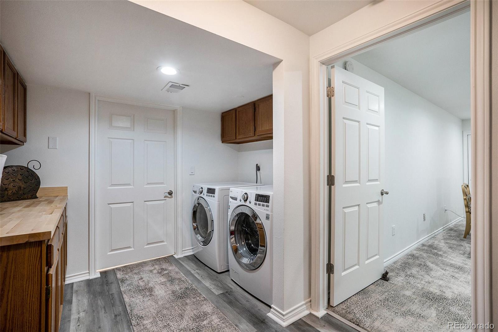 1600 South Quebec Way, Unit 10 Denver, CO 80231 - Photo 20 of 29 a view of storage and utility room with washer and dryer