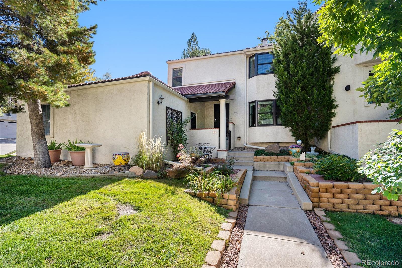 1600 South Quebec Way, Unit 10 Denver, CO 80231 - Photo 24 of 29 a front view of a house with patio
