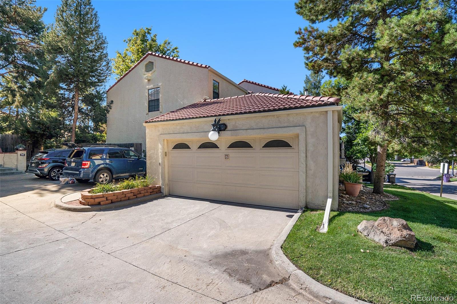 1600 South Quebec Way, Unit 10 Denver, CO 80231 - Photo 25 of 29 a front view of a house with a yard