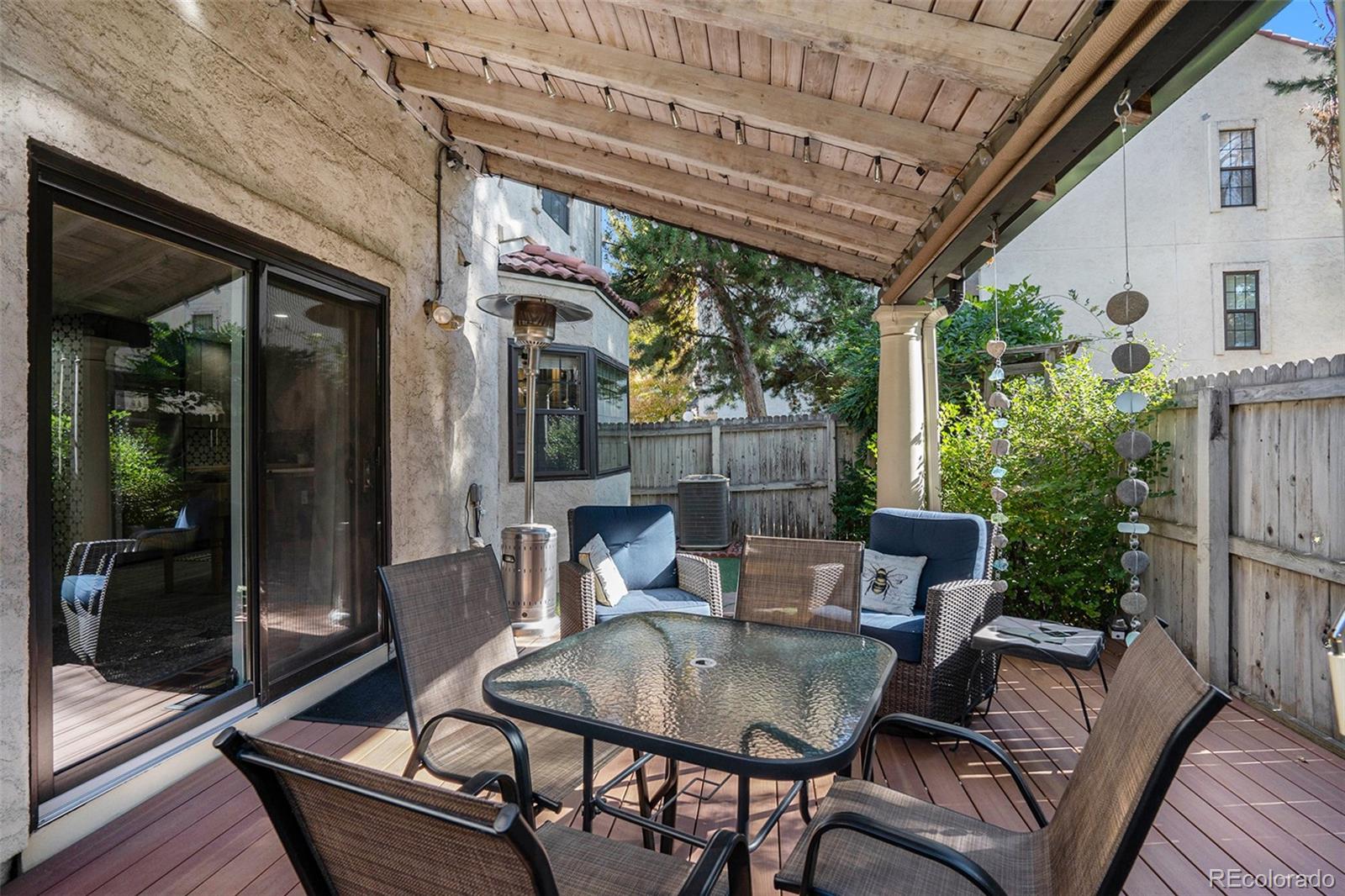 1600 South Quebec Way, Unit 10 Denver, CO 80231 - Photo 26 of 29 a view of patio with table and chairs and potted plants