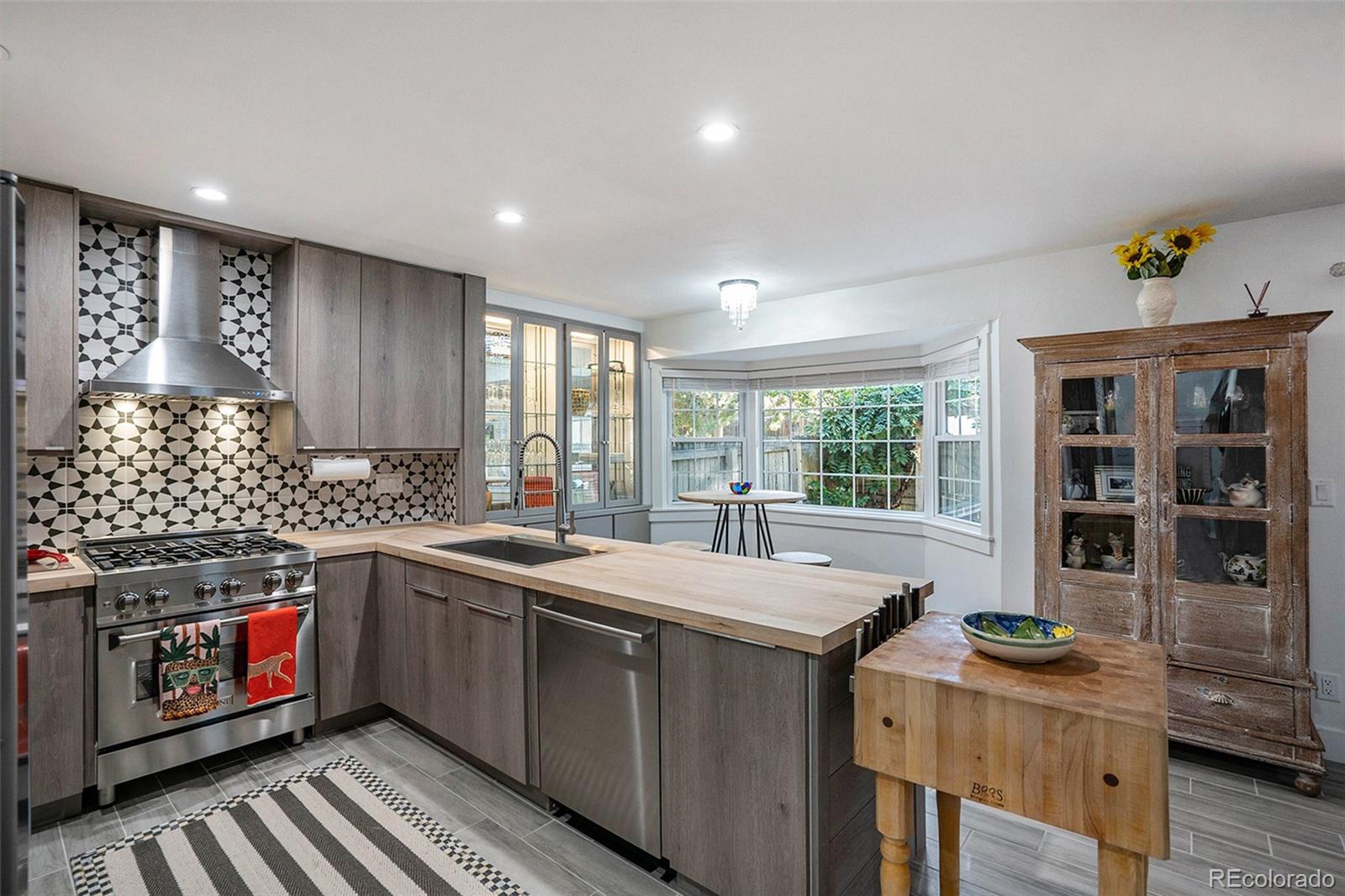 1600 South Quebec Way, Unit 10 Denver, CO 80231 - Photo 4 of 29 a kitchen with stainless steel appliances granite countertop a stove a sink and a microwave