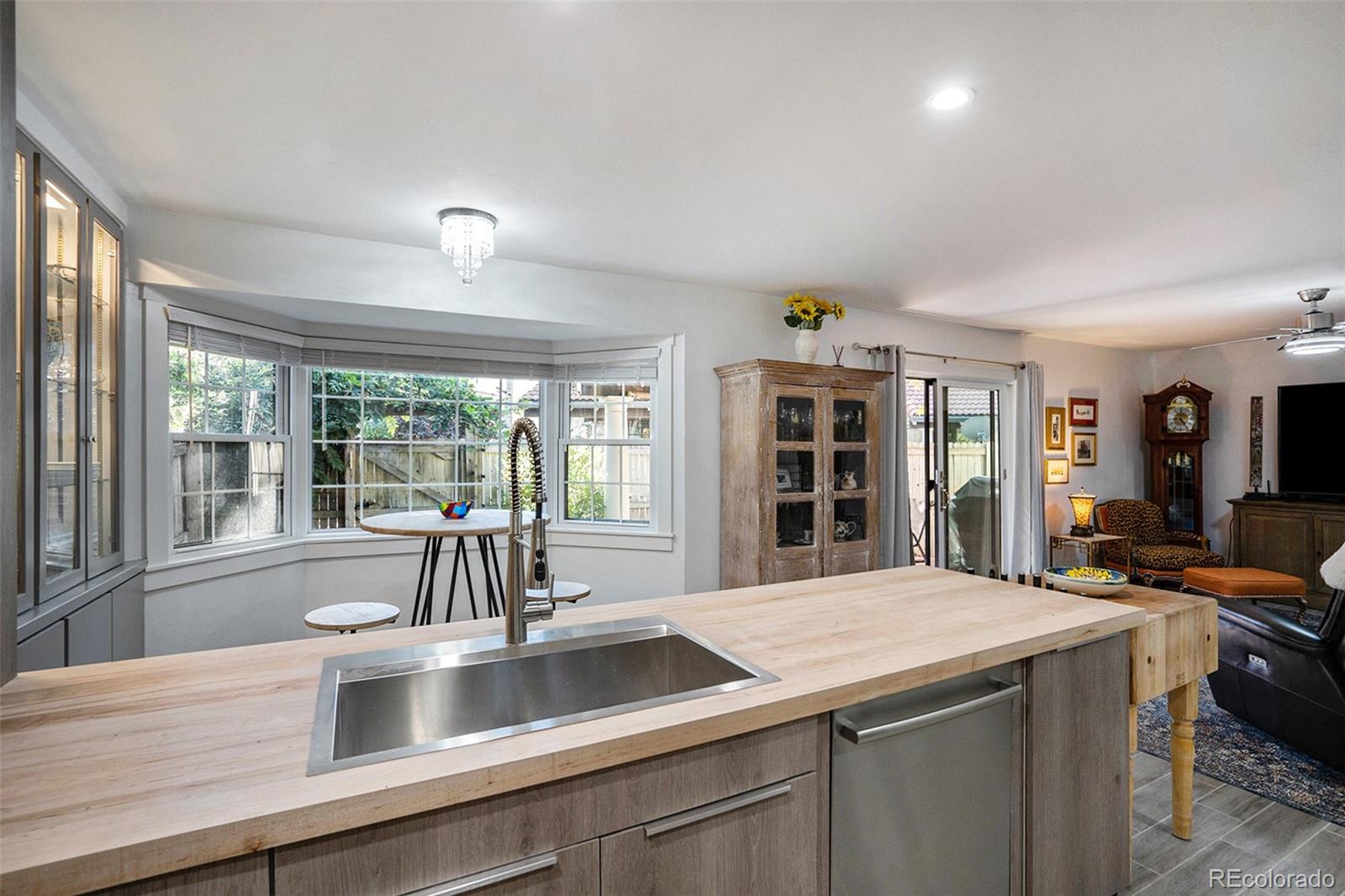 1600 South Quebec Way, Unit 10 Denver, CO 80231 - Photo 6 of 29 a kitchen with a sink and large windows