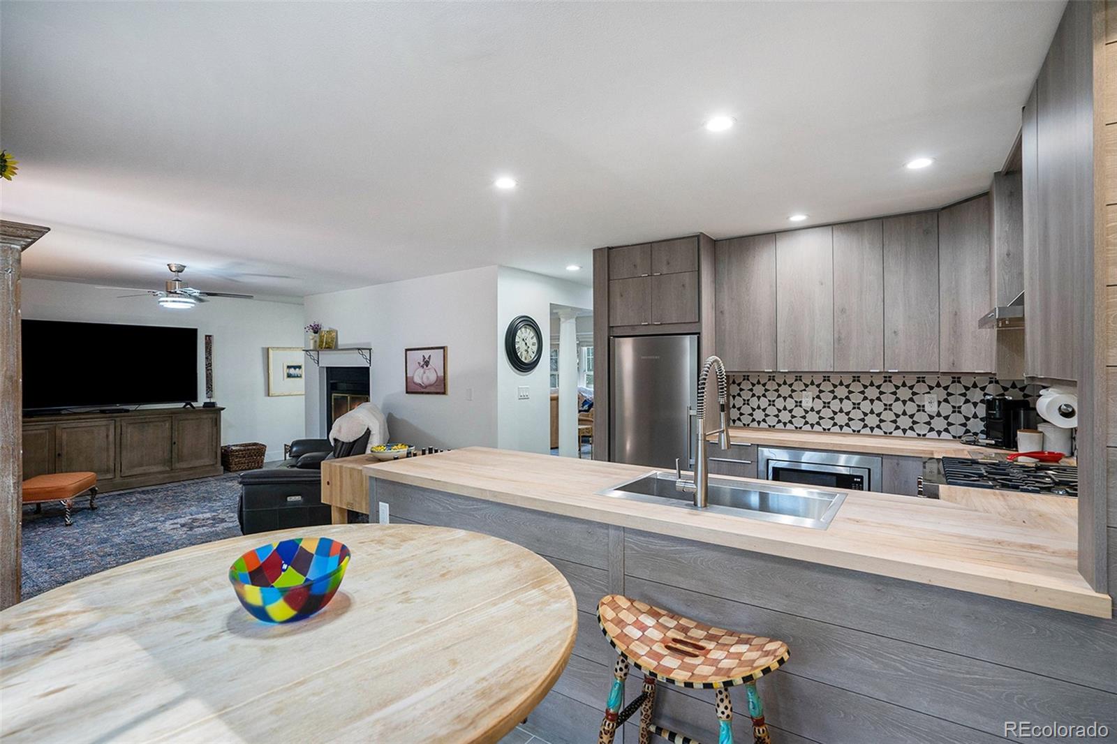 1600 South Quebec Way, Unit 10 Denver, CO 80231 - Photo 7 of 29 a kitchen with kitchen island granite countertop a sink and a refrigerator