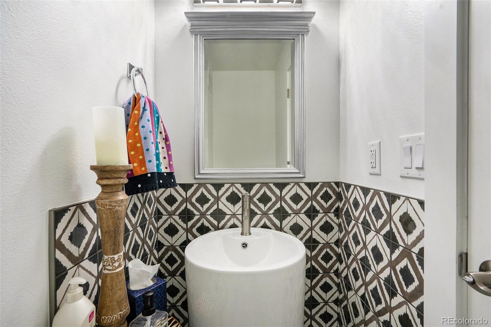 1600 South Quebec Way, Unit 10 Denver, CO 80231 - Photo 8 of 29 a bathroom with a sink and a mirror