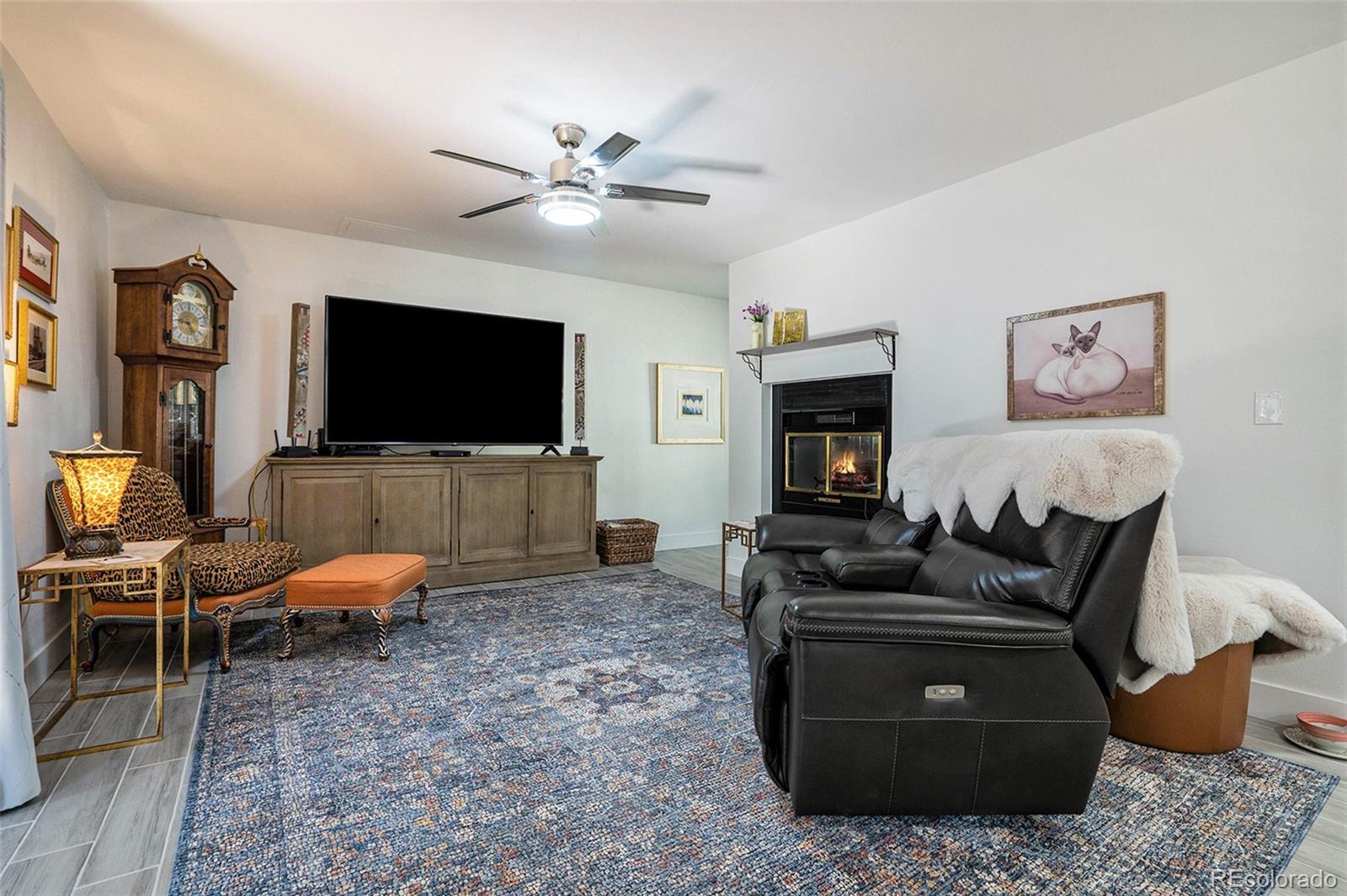 1600 South Quebec Way, Unit 10 Denver, CO 80231 - Photo 9 of 29 a living room with furniture and a flat screen tv