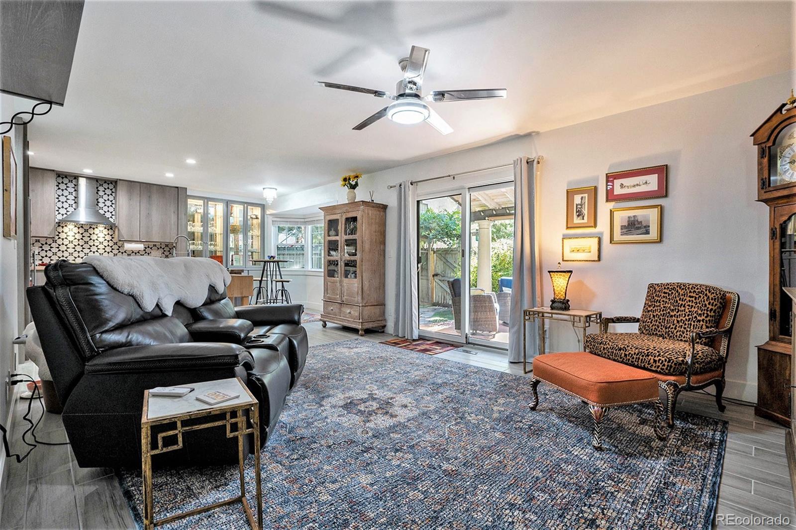 1600 South Quebec Way, Unit 10 Denver, CO 80231 - Photo 10 of 29 a living room with furniture a ceiling fan and a rug