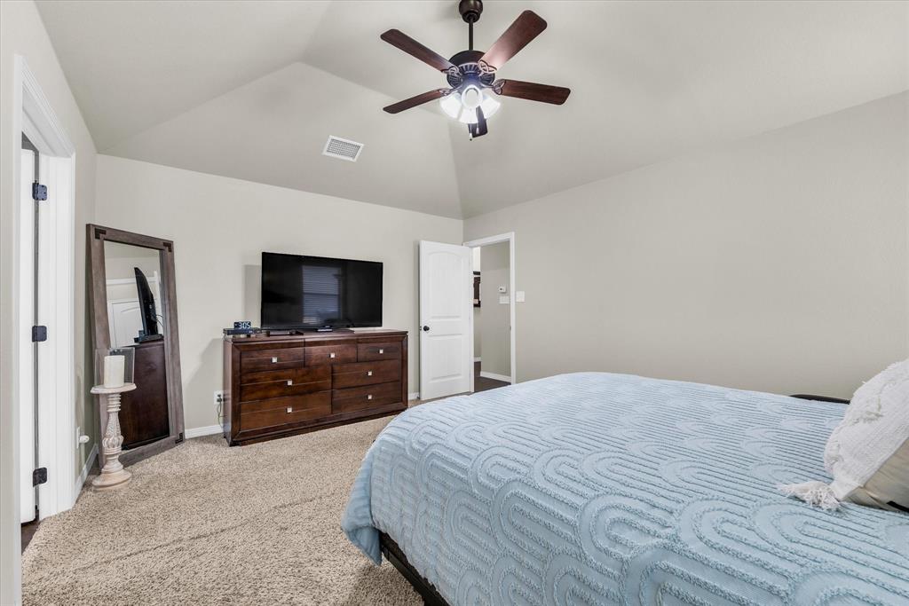 814 Springdale Circle Lorena, TX 76655 - Photo 19 of 37 Carpeted room featuring a vaulted ceiling with a ceiling fan, light-toned wall paint, and white trim doors