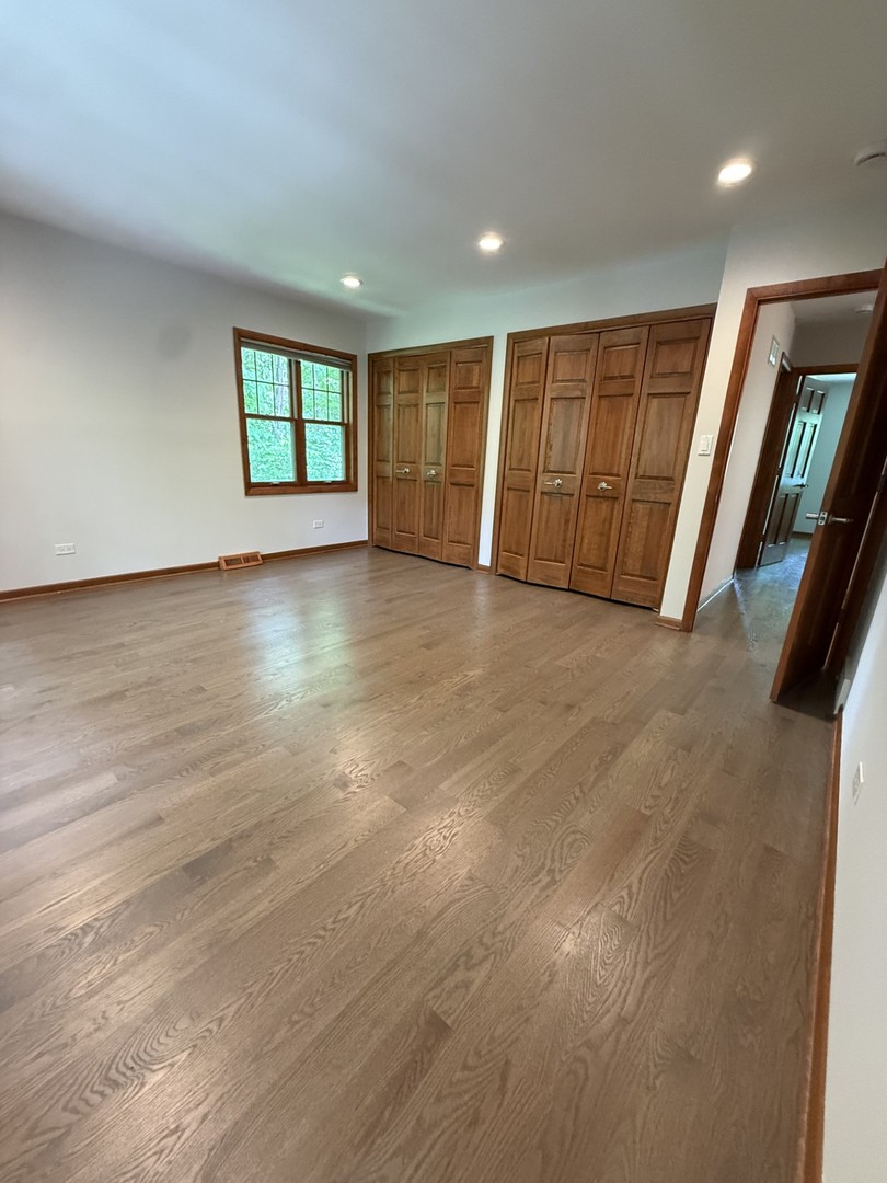 2841 Orange Brace Road Deerfield, IL 60015 - Photo 15 of 30 an empty room with wooden floor and windows
