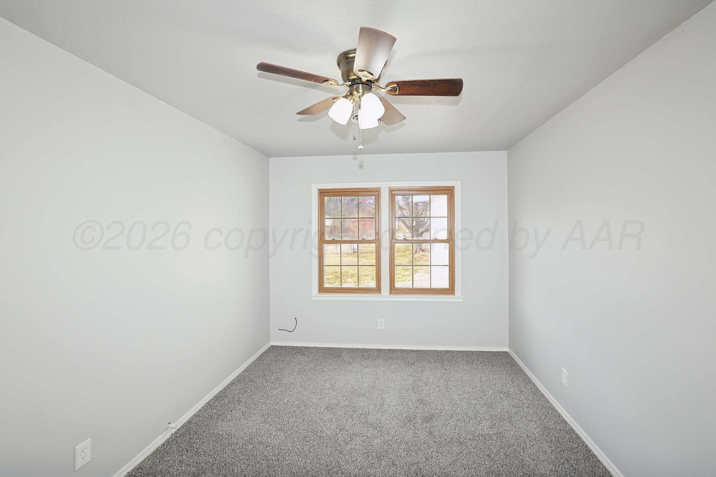 1602 Tularosa Street Amarillo, TX 79102 - Photo 17 of 33 an empty room with a window and a fan