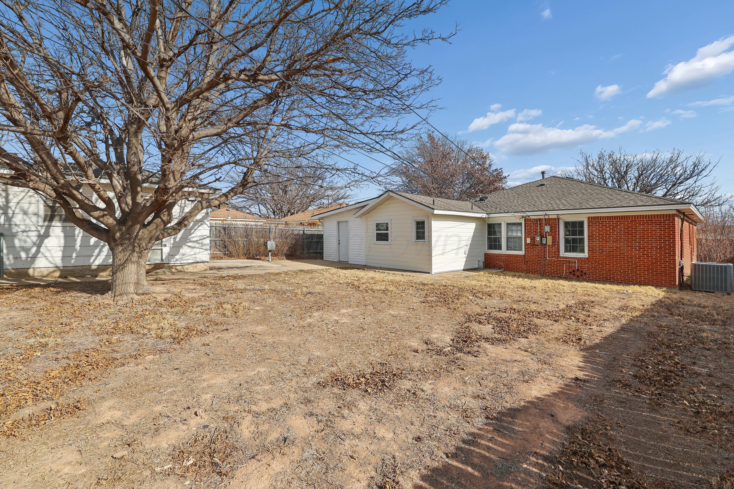1602 Tularosa Street Amarillo, TX 79102 - Photo 28 of 33 a front view of a house with a yard covered in snow