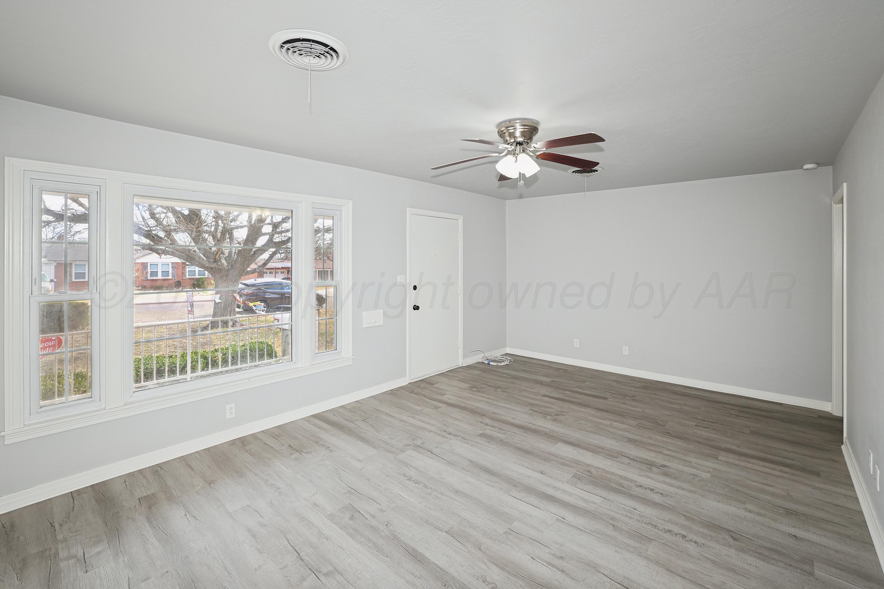 1602 Tularosa Street Amarillo, TX 79102 - Photo 5 of 33 wooden floor in an empty room with a window