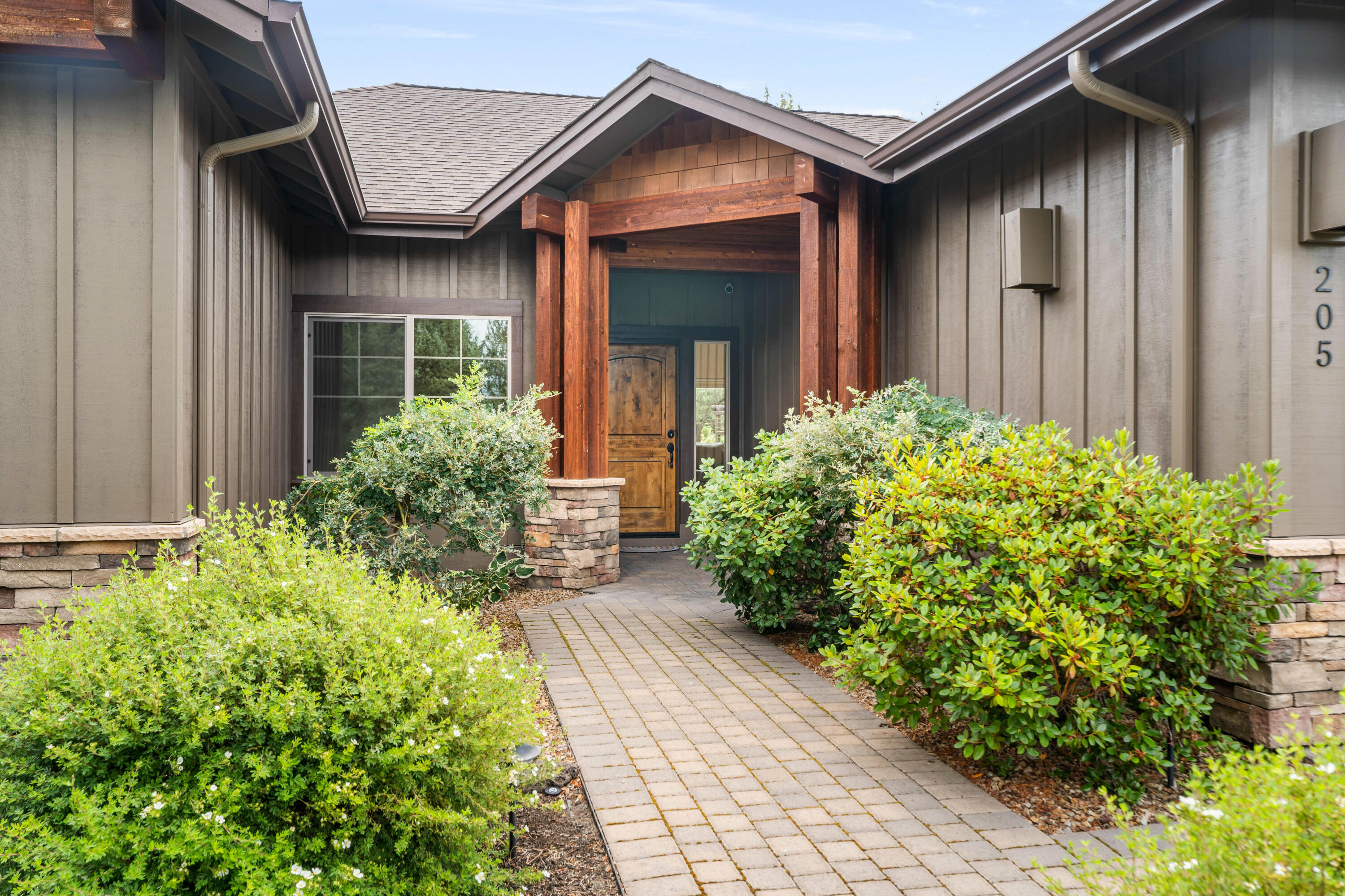 205 Vista Rim Drive Redmond, OR 97756 - Photo 2 of 85 front view of the house with potted plants