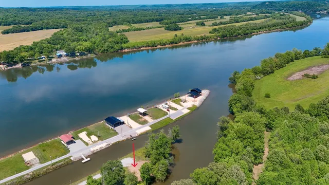 an aerial view of a house with a lake view