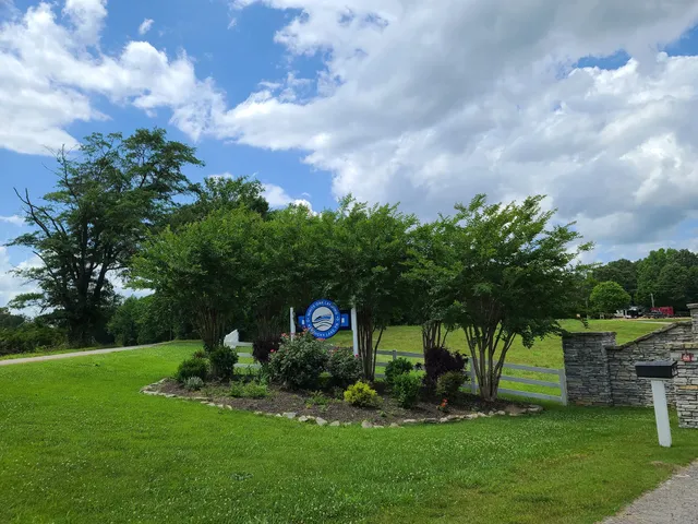 a view of a garden with a house in the background