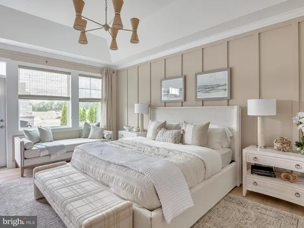 a bedroom with a bed a couch and large window