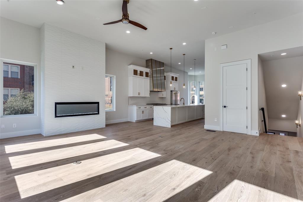 250 East Dallas Road, Unit 114 Grapevine, TX 76051 - Photo 11 of 33 a living room with stainless steel appliances kitchen island granite countertop furniture and a fireplace
