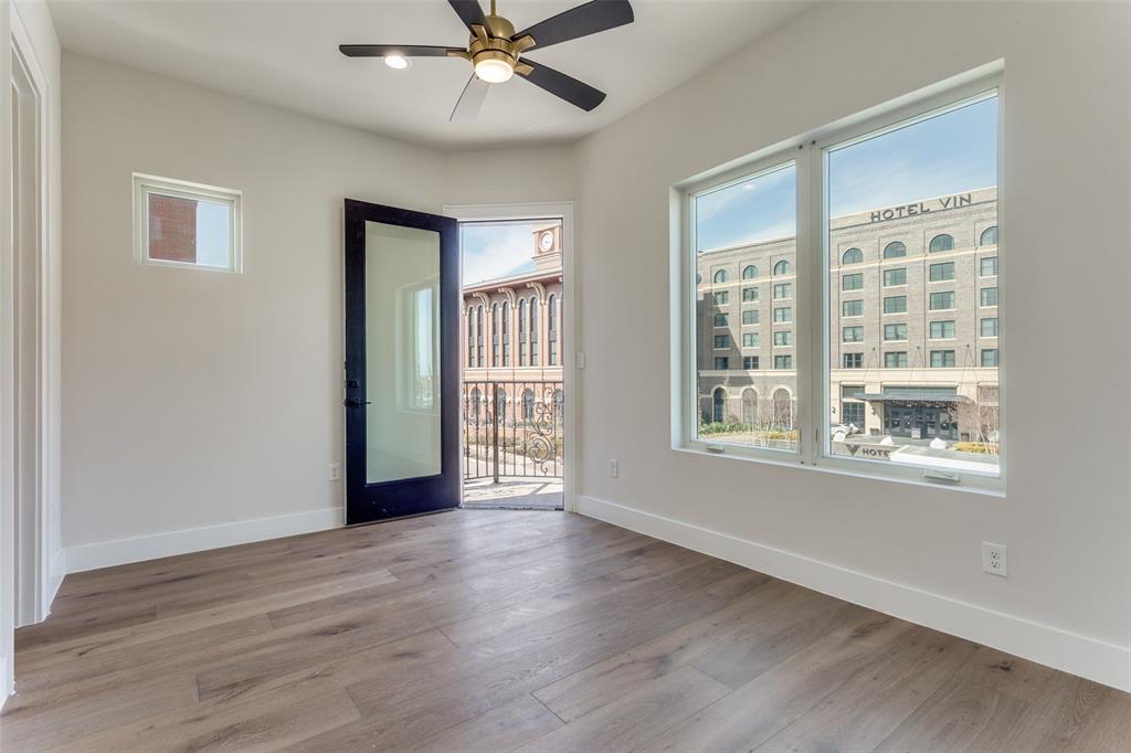 250 East Dallas Road, Unit 114 Grapevine, TX 76051 - Photo 24 of 33 a view of an empty room with wooden floor and a window
