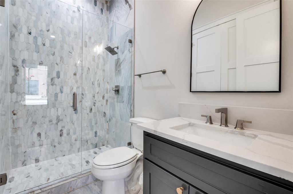 250 East Dallas Road, Unit 114 Grapevine, TX 76051 - Photo 25 of 33 a bathroom with a sink a toilet and shower