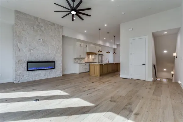 a view of an empty room with a ceiling fan and window
