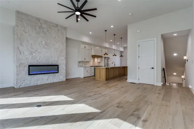 a view of an empty room with a ceiling fan and window