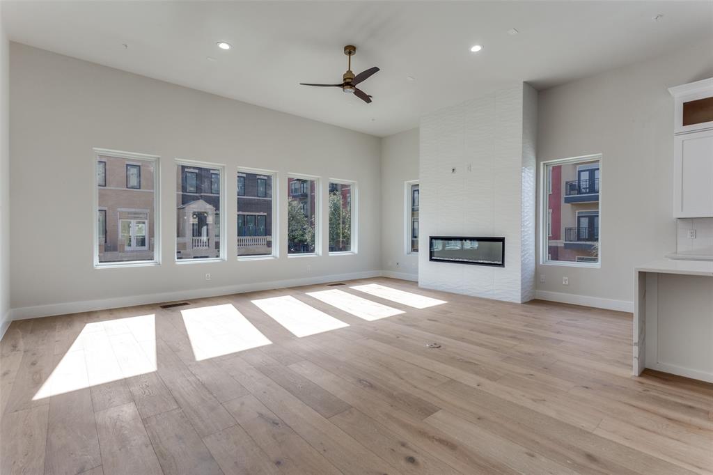 250 East Dallas Road, Unit 114 Grapevine, TX 76051 - Photo 10 of 33 a view of an empty room with wooden floor and a window