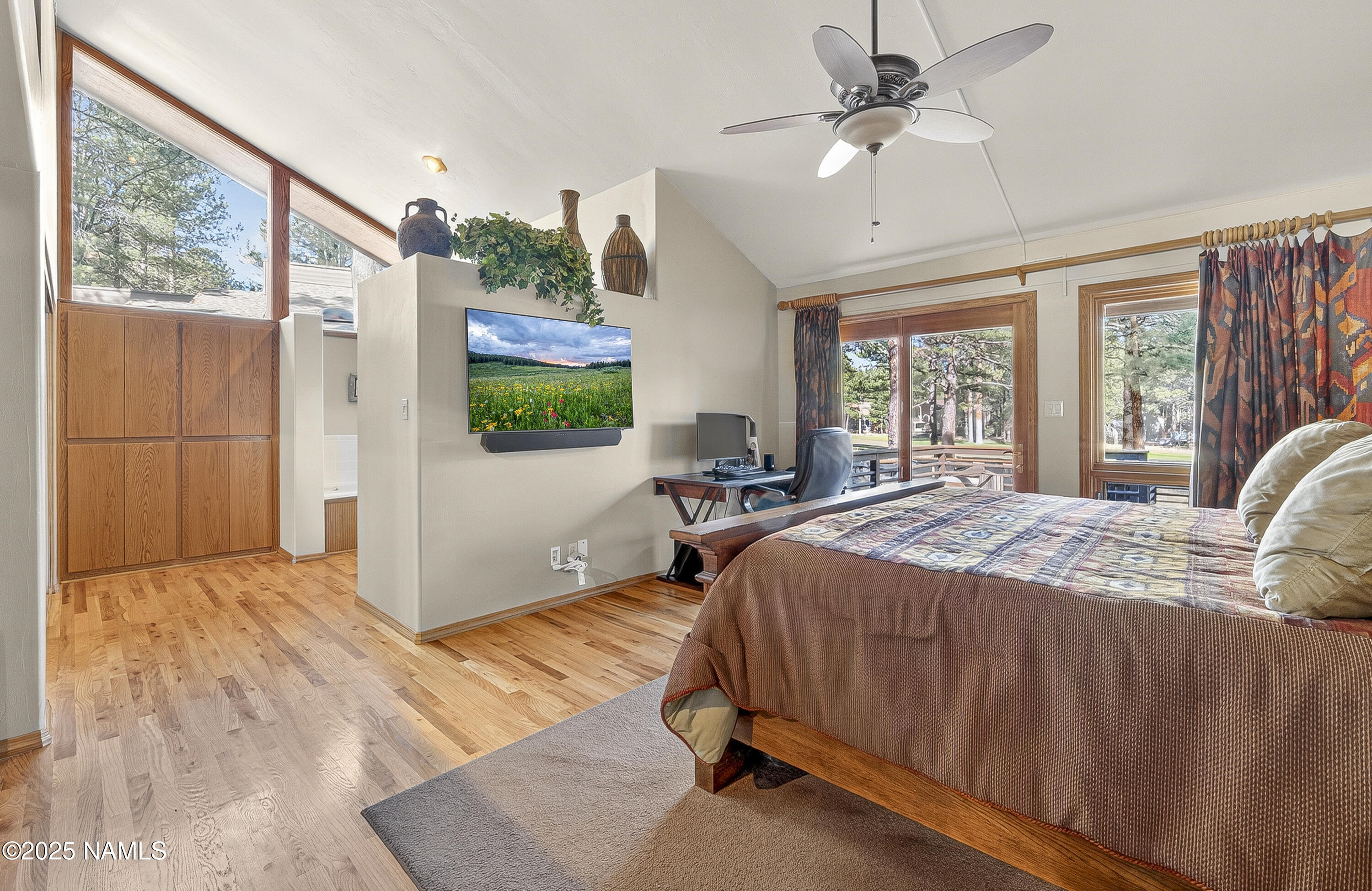 5790 Griffiths Spring Flagstaff, AZ 86005 - Photo 27 of 47 a spacious bedroom with a bed a window and flat screen tv