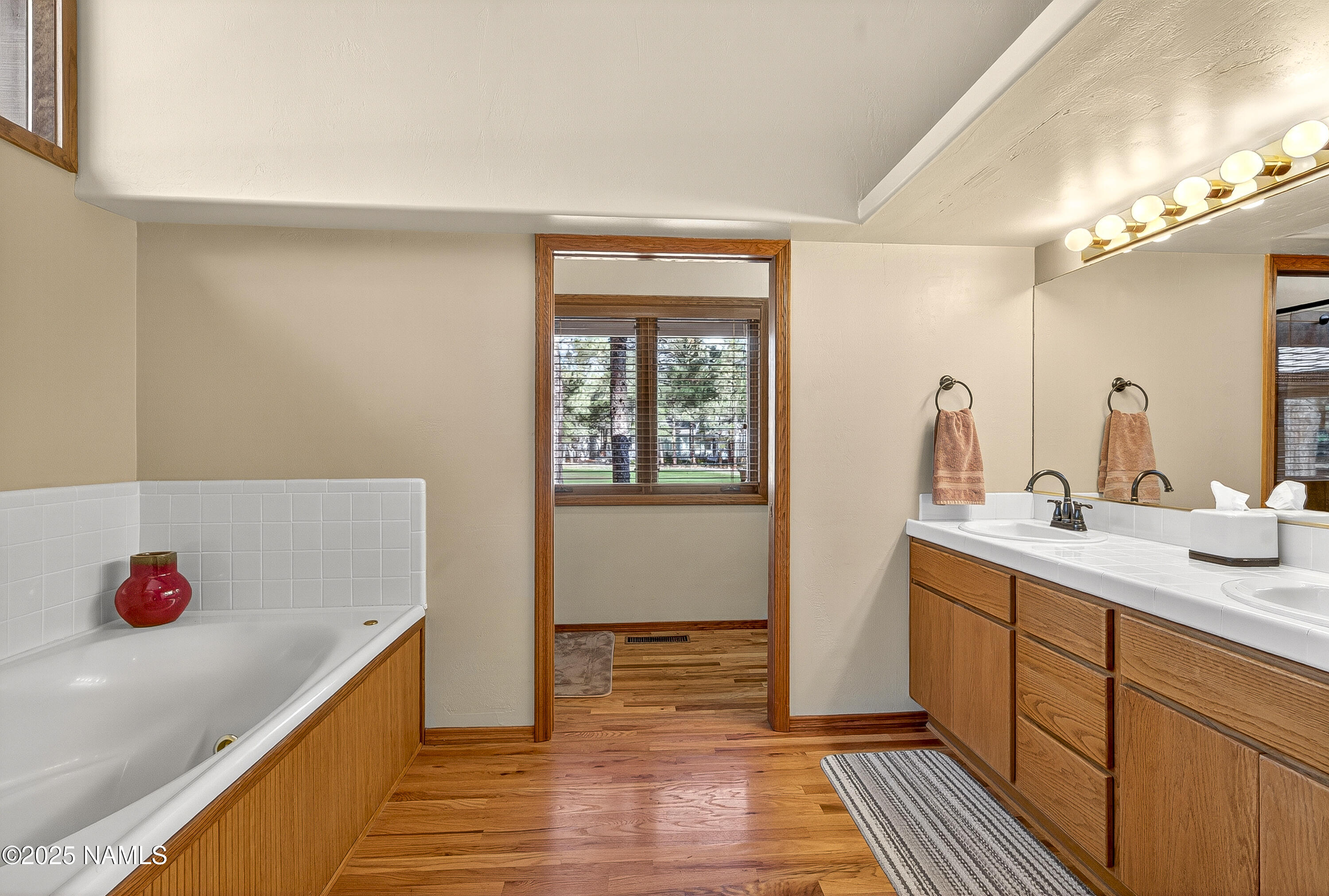 5790 Griffiths Spring Flagstaff, AZ 86005 - Photo 30 of 47 a bathroom with a double vanity sink and a mirror