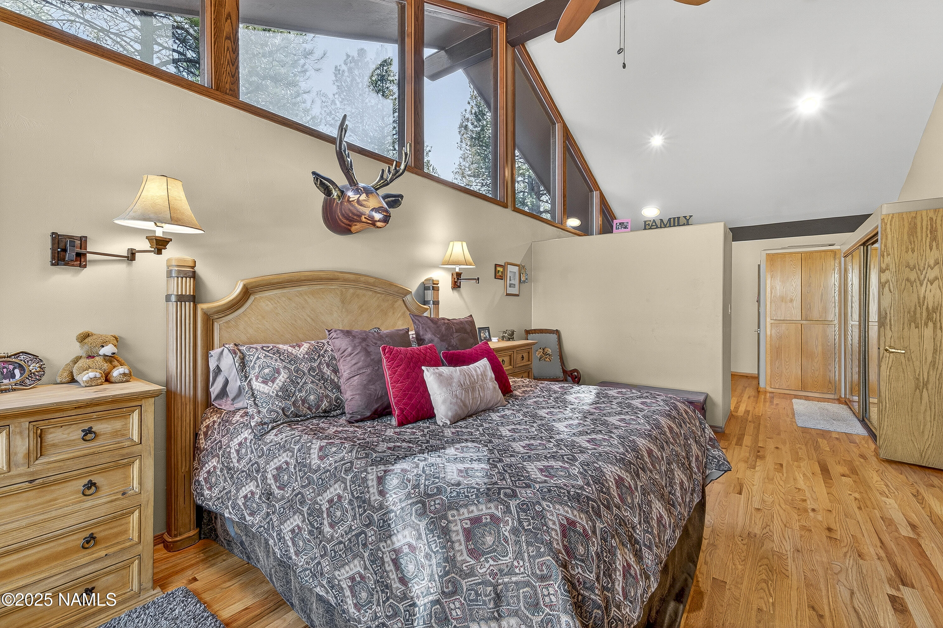 5790 Griffiths Spring Flagstaff, AZ 86005 - Photo 32 of 47 a bedroom with a large bed and a chandelier