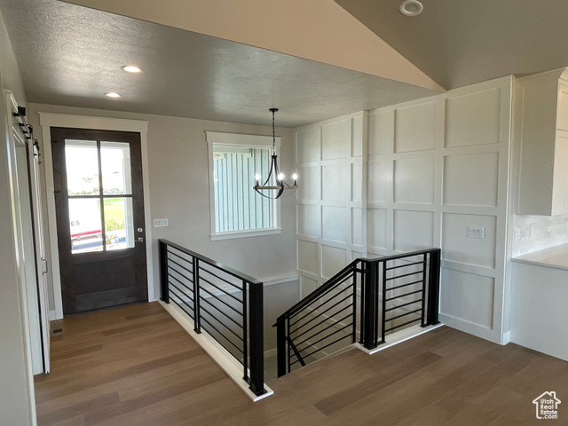 658 West 500 South Logan, UT 84321 - Photo 16 of 25 Entrance foyer with dark wood finished floors, recessed lighting, a barn door, and a chandelier
