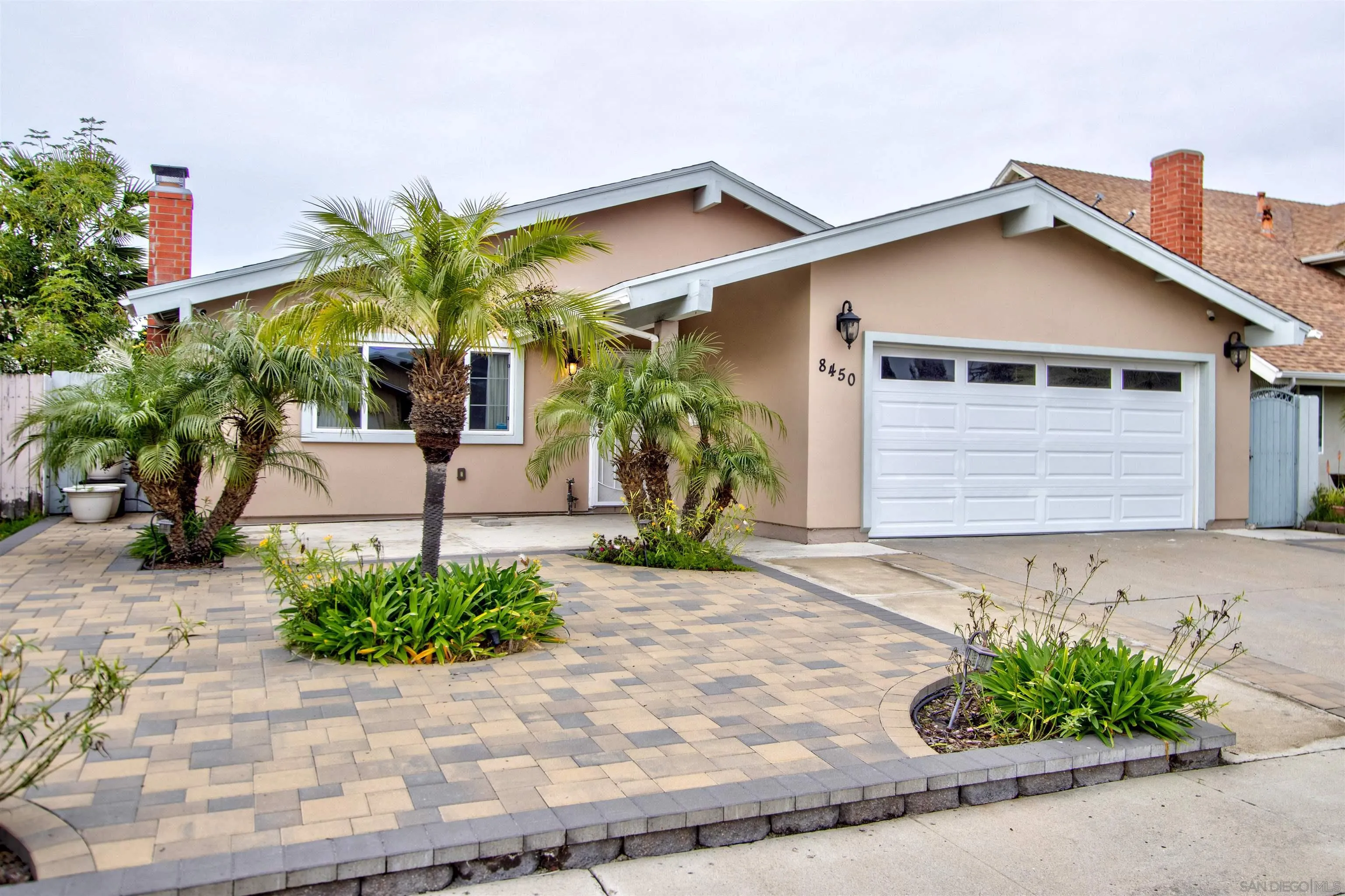 a front view of a house with a yard and a garage
