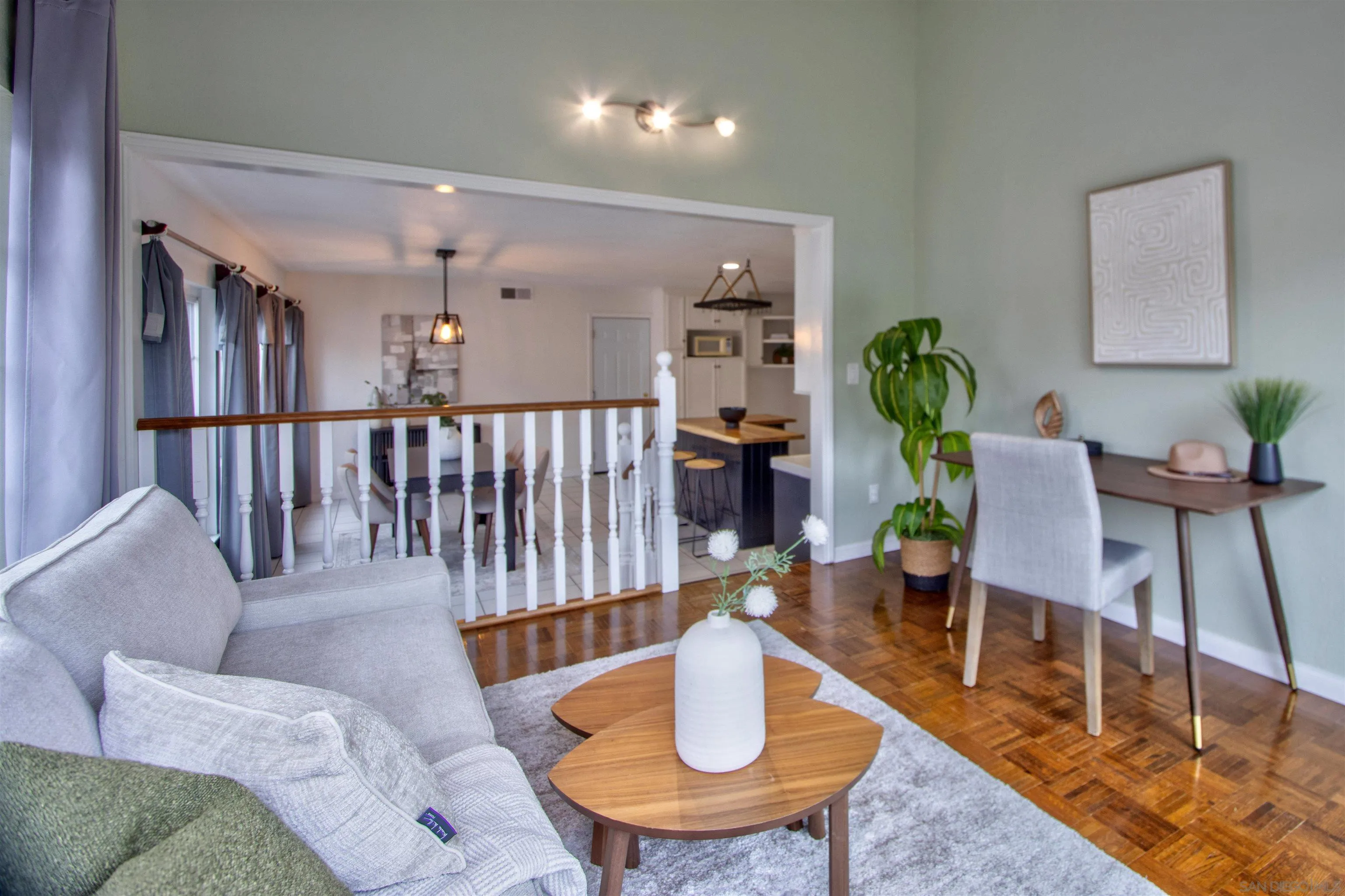 8450 Aries Road San Diego, CA 92126 - Photo 15 of 25 a living room with couches and a dining table with garden view