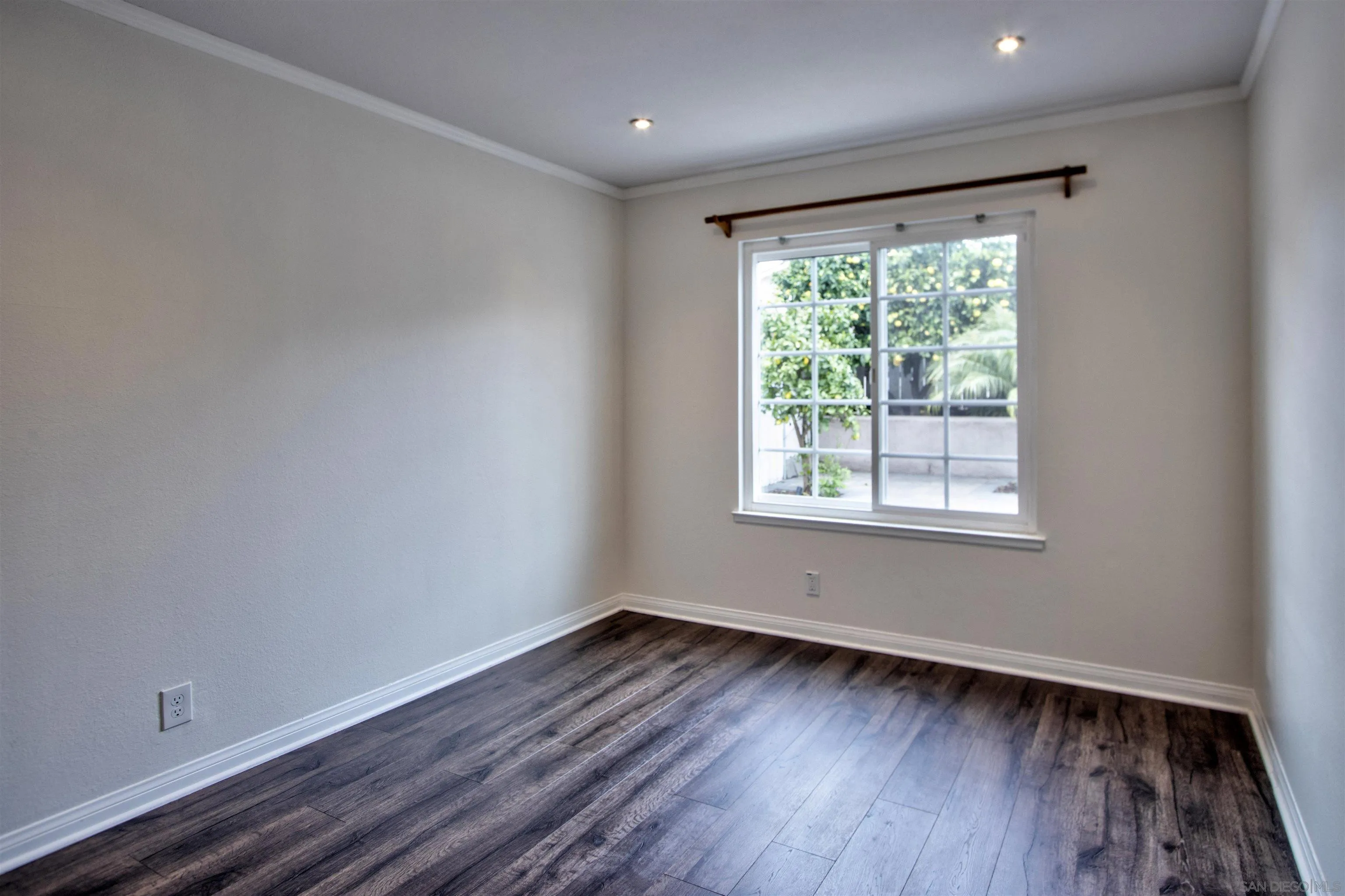 8450 Aries Road San Diego, CA 92126 - Photo 19 of 25 a view of a room with wooden floor and window