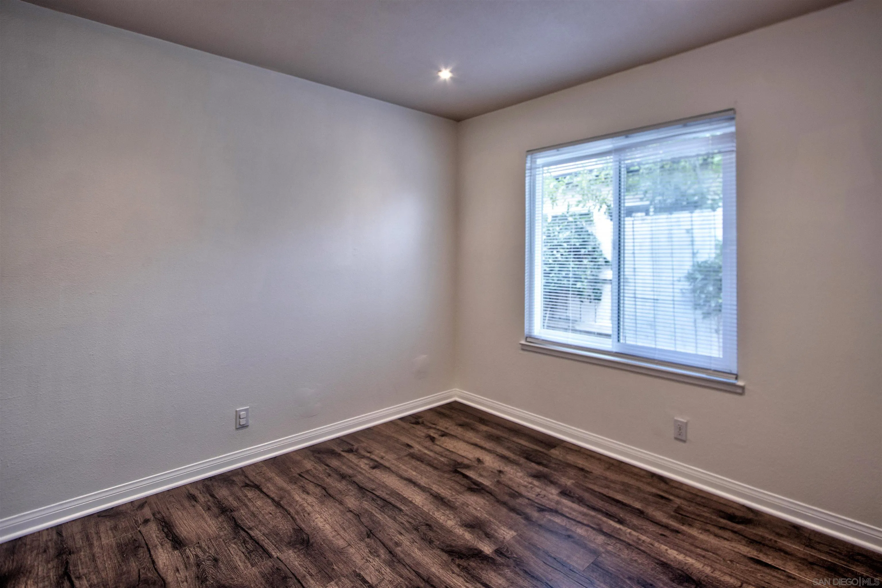 8450 Aries Road San Diego, CA 92126 - Photo 20 of 25 a view of a room with wooden floor and windows