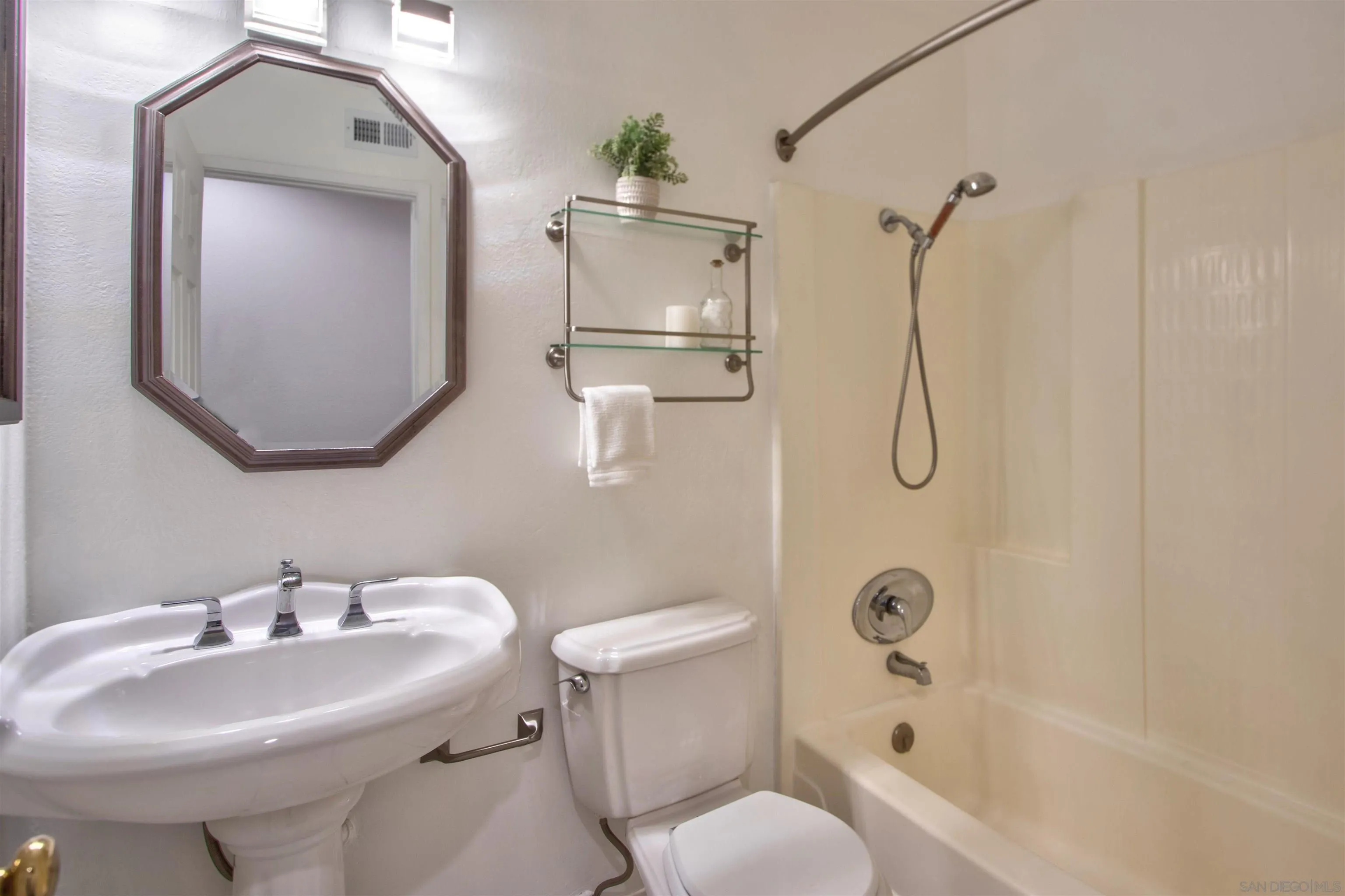 8450 Aries Road San Diego, CA 92126 - Photo 21 of 25 a bathroom with a sink toilet and shower