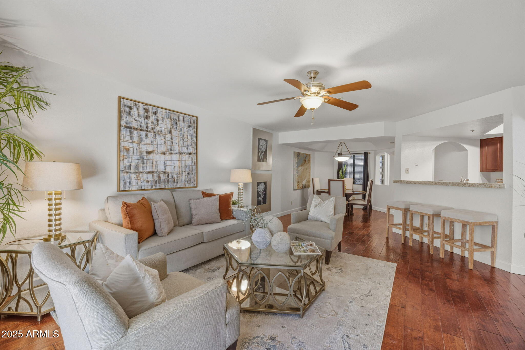 a living room with furniture a table and a potted plant