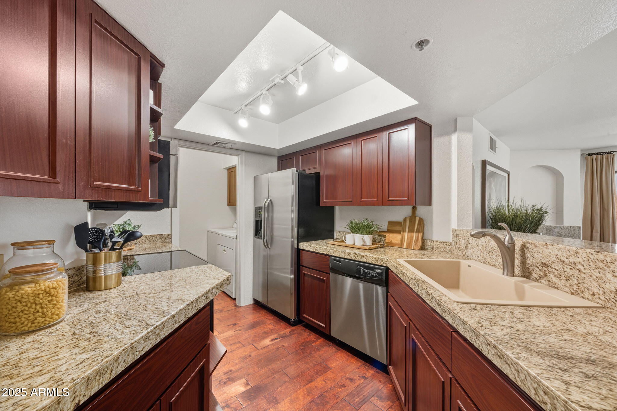 5104 North 32nd Street, Unit 344 Phoenix, AZ 85018 - Photo 11 of 30 a kitchen with granite countertop stainless steel appliances a sink stove refrigerator and cabinets